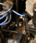 Using 10-Piece Metric Flare Nut Crowfoot Wrench Set For Tight Spots And Obstructed Fasteners on engine bolts, showcasing 6-point heads.