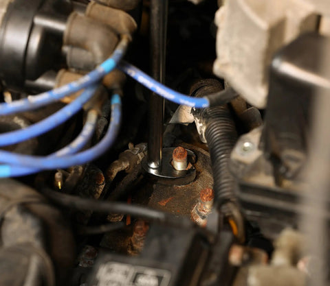 Using 10-Piece Metric Flare Nut Crowfoot Wrench Set For Tight Spots And Obstructed Fasteners on engine bolts, showcasing 6-point heads.