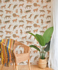 Bright Tangerine Kitty Kitty Peel And Stick Wallpaper In Off White With Exotic Cat Pattern in living room with chair and plant