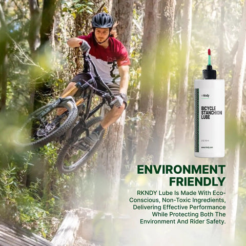 Cyclist on mountain bike with fork stanchion and shock lube bottle, ensures smooth suspension and all-weather performance.