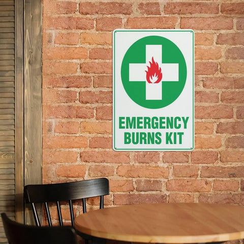 Emergency Burn Care Sign 8x12 Inches Aluminum Warning Plate on brick wall, showing green cross and fire symbol, for safety reminder.