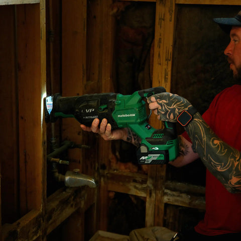Person using 36V MultiVolt Brushless Reciprocating Saw Kit with 18V 36V Battery, Rapid Charger, Curved Wood Blade in home construction project