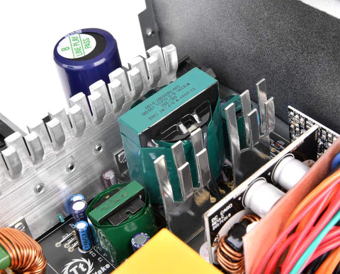 Close-up of 600W 80 Plus Gold Non Modular ATX Power Supply with Ultra Quiet 120mm Fan showing internal components and capacitors.