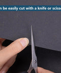 Nkiy Quen gasket material sheet, 15x11.8 in, non-asbestos high-temperature sheet being cut with scissors