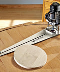 Circle Cutter Router Jig For Pro Grade Circle Cutting From 10 Inch To 52 Inch Diameter Includes Pivot Pins And Mounting Hardware Fits Most Popular Routers in use on a wooden table.