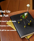 Wind Up Office Desk Pet Toy For Home And Work Cute Dancing Companion That Walks Across The Table on a notebook