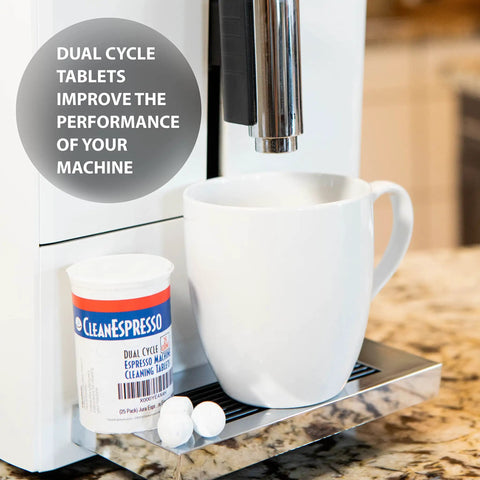 Dual Cycle Cleaning Tablets For Jura Coffee Machines 3.5g Each shown beside a coffee machine with a cup on the tray.