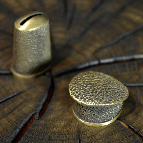 Close-up of Finger Guard Bolster And Pommel Knife Making Set Hand Cast Bronze Dirk 1 on wood surface