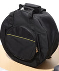 Road Ready Snare Drum Case And Gig Bag With Badass Thickened Padding And Adjustable Shoulder Strap For Smooth Hauling Of Your 14 Or 15 Inch Snare In Sleek Matte Black, shown from side angle.