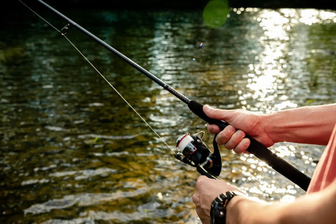 Angler holding GX2 Spinning Rod With Enhanced Balance And Durable Build For Serious Anglers, Six Foot Six Inch Length while fishing