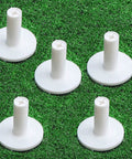 Five Pack 1.5 Inch Rubber Tee Adapters For Indoor Outdoor Golf Practice Mats White Tee Holder Set Fits Wood And Plastic Tees Durable Universal Tee Support For Hitting Mats And Range Ready evenly arranged on green turf.
