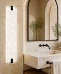 22" Natural Square Alabaster Marble Modern Bathroom Black Wall Sconce illuminated beside a contemporary bathroom vanity.