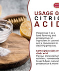 Citric acid powder in a glass bowl on a wooden board with a lemon; Spicy World logo visible (front view)
