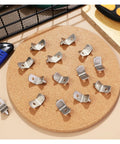 Heavy Duty L Shape Shelf Brackets Pins Set for Kitchen Cabinets Bookcases and Closets on cork board with tools nearby