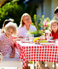 Family enjoying outdoor meal with 24 Piece Teardrop Tablecloth Weights With Marble Pendant Stones And Metal Clips For Outdoors, Marble Teardrop Table Cover Weights Hangers For Picnic, Parties, Backyard BBQs, White