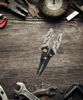 Pretyzoom 7-In-1 Cable Stripper And Crimper For Electricians on a wooden surface among various tools.