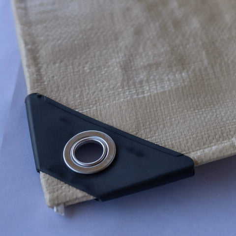 Close-up of corner grommet on Heavy Duty Waterproof Tarp 20 Ft By 30 Ft 12 Mil Thick Tan Tarp With Reinforced Corners And Rope Hem