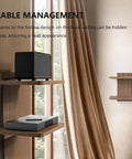 Wall Mounted Two Tier Floating Media Shelf In Rich Walnut Brown For Projectors And DVD Players With No Sweat Cable Routing And Heavy Duty Build To Secure All Your Rec Room Entertainment Gear showcasing cable management with a speaker and player.