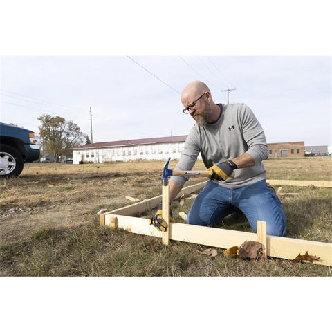 Man using Framing Hammer 24oz With Hickory Handle 999 Series Milled Face Made In USA Heavy Duty Demolition Tool for framing work outdoors