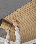 Effortless Peel And Stick 3D Wall Panels Self Adhesive Soundproof Removable PVC Slat Tiles Dark Brown Wood Grain being installed on ceiling.