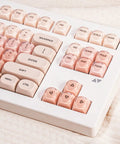Close-up of Clean 80 Percent Wireless Mechanical Keyboard In Soft Pink Creamy Build featuring transparent keycaps.