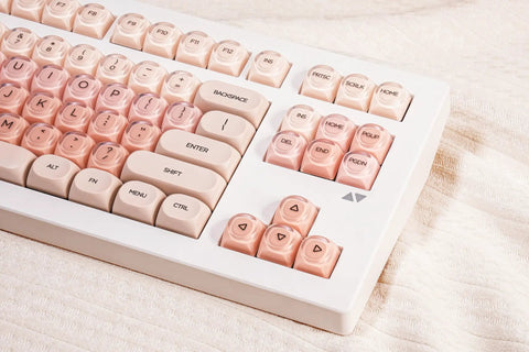 Close-up of Clean 80 Percent Wireless Mechanical Keyboard In Soft Pink Creamy Build featuring transparent keycaps.