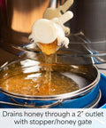 Electric Honey Extractor 8 Frame Rack With 4 Deep Frames draining honey through 2-inch outlet into blue container