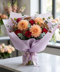 Bouquet wrapped in Boss Florist Pop Up Tissue Sheets For Flowers 266 Waterproof Bouquet Paper Easy Peel Dispensing on table.