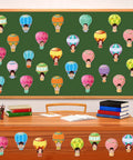 Colorful Hot Air Balloon Cutouts Kit 60 Pcs 6 By 6 Inch Bulletin Board Decor For Classroom And Office Back To School 12 Styles With Adhesive Dots displayed on a classroom board.