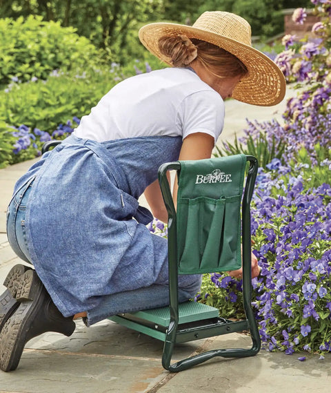 Person using Do It All Garden Kneeler Seat With Padded Cushion And Detachable Tool Bag, Versatile Foldable Garden Stool for comfort weeding.