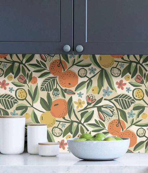 Pip And Lo Ochre Clementine Garden Peel And Stick Wallpaper installed as kitchen backsplash, showing fruit and leaves design.