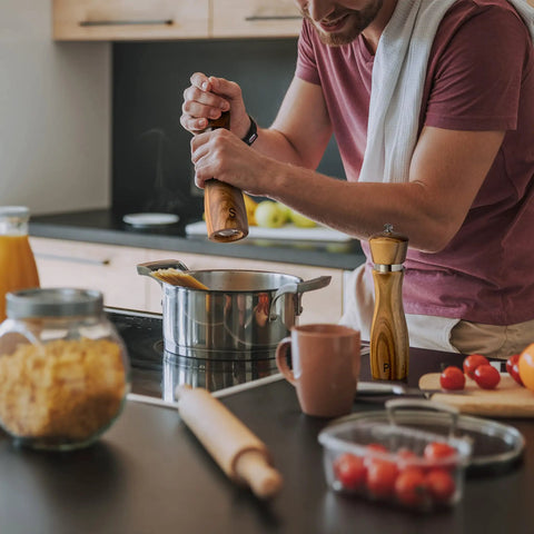 Person using Wooden Salt And Pepper Grinder Set Refillable Mills With Adjustable Coarseness Crafted From Solid Acacia Wood With Ceramic Core