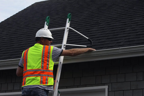 Worker using Ladder Stabilizer Standoff Brackets With Foam Elbows Sold In Pairs For Aluminum And Fiberglass Ladders on a roof