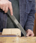Workhorse 4 In 1 Wood Rasp File 8 Inch Straight Shooting Shaping Tool in use on wooden block during carpentry.