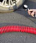 Heavy Duty Polyurethane Recoil Air Hose Self Coiling Compressor Line 1/4 In By 25 Ft connected to a tire pressure gauge.