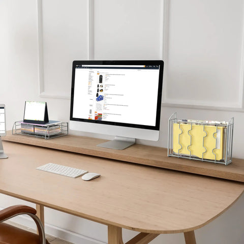 Home office desk with computer, organizer trays, and file holder. Modern workspace setup.