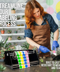 Rock Solid Acrylic Label Dispenser With Grippy Non Slip Base Keeps Your Sticker Rolls Tied Down Tight in use for labeling plants.