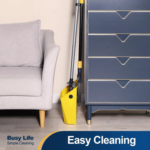 Commercial Broom And Dustpan Set With 54 Inch Long Handle For Indoor Outdoor Cleaning near a gray sofa and blue dresser