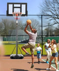 Man playing basketball with Backyard Portable Adjustable Basketball Hoop System for Indoor Outdoor Play, 44 Inch Backboard