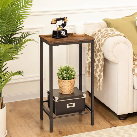 Built Tough Industrial Tall Side Table Featuring Adjustable Mesh Shelves And Rugged Steel Frame Works Like A Charm As A Tall Nightstand For Your Rustic Brown Living Room Setup, showcasing a black phone and potted plant.