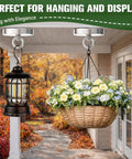 Two ceiling-mounted magnetic hooks suspend a black metal lantern and a wicker flower basket.