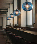 Stylish Hand Blown Glass Pendant Lights For Kitchen Island In Blue Marble Finish Modern Rustic Farmhouse Style With Brushed Nickel Hardware 8.7 Inch Diameter 2 Pack installed in kitchen