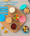 Six Pack Two Point Four Ounce Stainless Steel Dressing Containers With Silicone Lids filled with various sauces and snacks