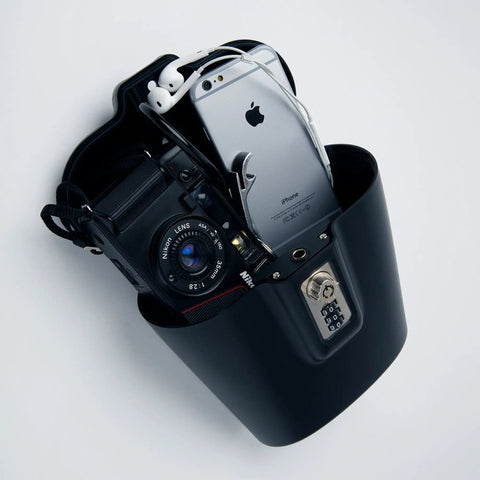 Portable Indoor Outdoor Lock Box Safe With Key And Combination Access filled with phone, camera, earbuds, steel build.