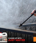 Person using heavy duty deck stain and coating remover on wooden railing, demonstrating easy cleaning with zero harsh fumes.
