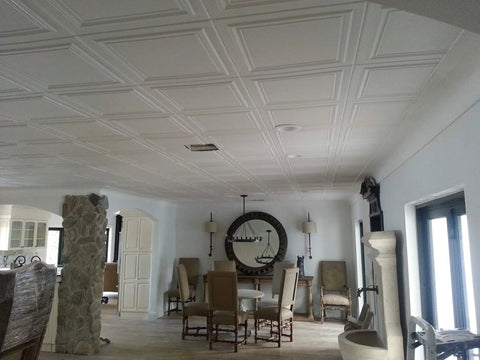 Interior view showing installed Glue Up Foam Ceiling Tiles White Pack Of Eight Covering 21.6 Square Feet Lightweight Insulating Popcorn Ceiling Cover Paintable With Water Based Paint Easy To Install And Clean in a dining room.