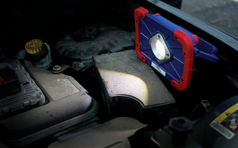 Beast Mode 1500 Lumen Rechargeable COB LED Work Light with magnetic base illuminating car engine area.