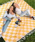 Versatile Turkish Cotton Picnic Blanket For Beach Park And Grass Large Outdoor Mat with two people sitting on a checkered blanket