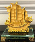 Gold Dragon Feng Shui Sailing Ship Statue For Home And Office Decor Boosts Fortune, Success, And Prosperity Dope Gift For Housewarmings, Graduations, Birthdays, And Special Occasions displayed on a glass base.