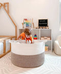 Child playing in XXL Cotton Rope Blanket Basket With Handles For Living Room Storage 21.7 Inches Square And 13.8 Inches Tall Handwoven